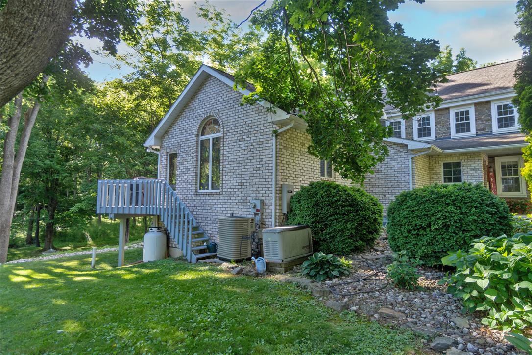 1325 Granger Road Northampton, PA 18067 - Photo 4 of 61 A private backyard oasis with mature trees and a charming deck, perfect for outdoor relaxation.