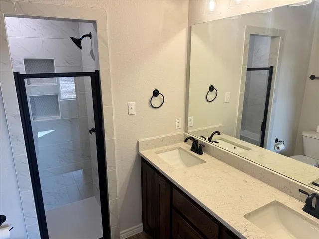 a bathroom with a granite countertop sink and mirror