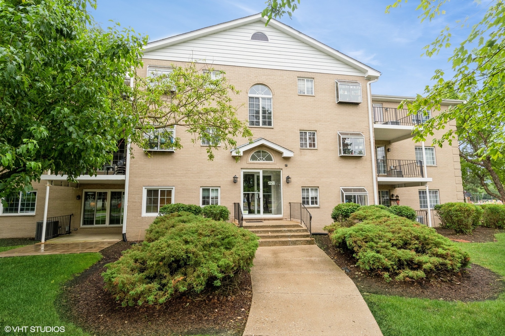 1258 Chalet Road, Unit 101 Naperville, IL 60563 - Photo 1 of 22 a front view of a house with a yard