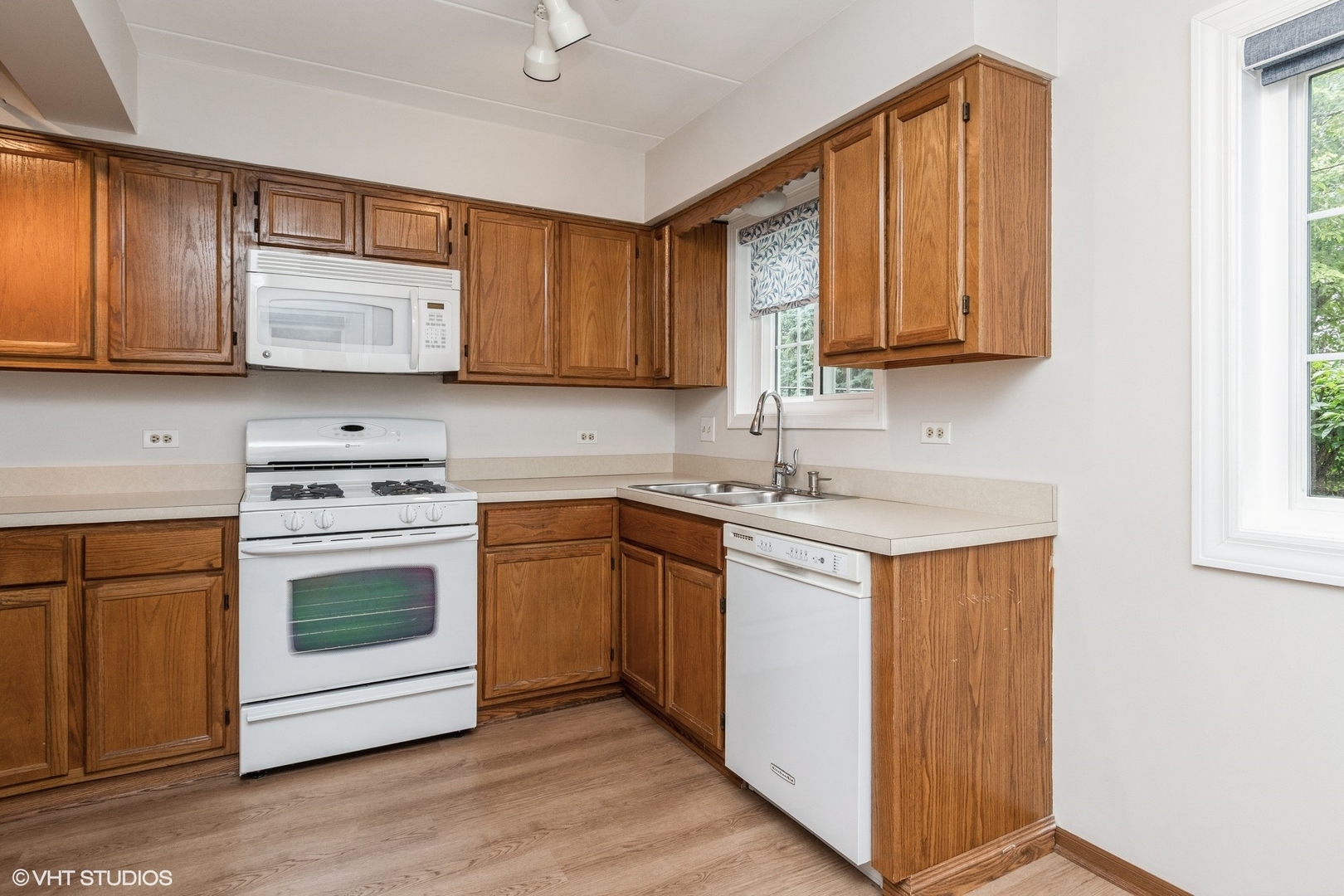 1258 Chalet Road, Unit 101 Naperville, IL 60563 - Photo 9 of 22 a kitchen with stainless steel appliances granite countertop wooden cabinets a sink and a stove
