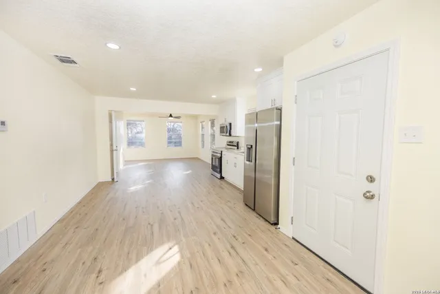 a view of a living room with wooden floor