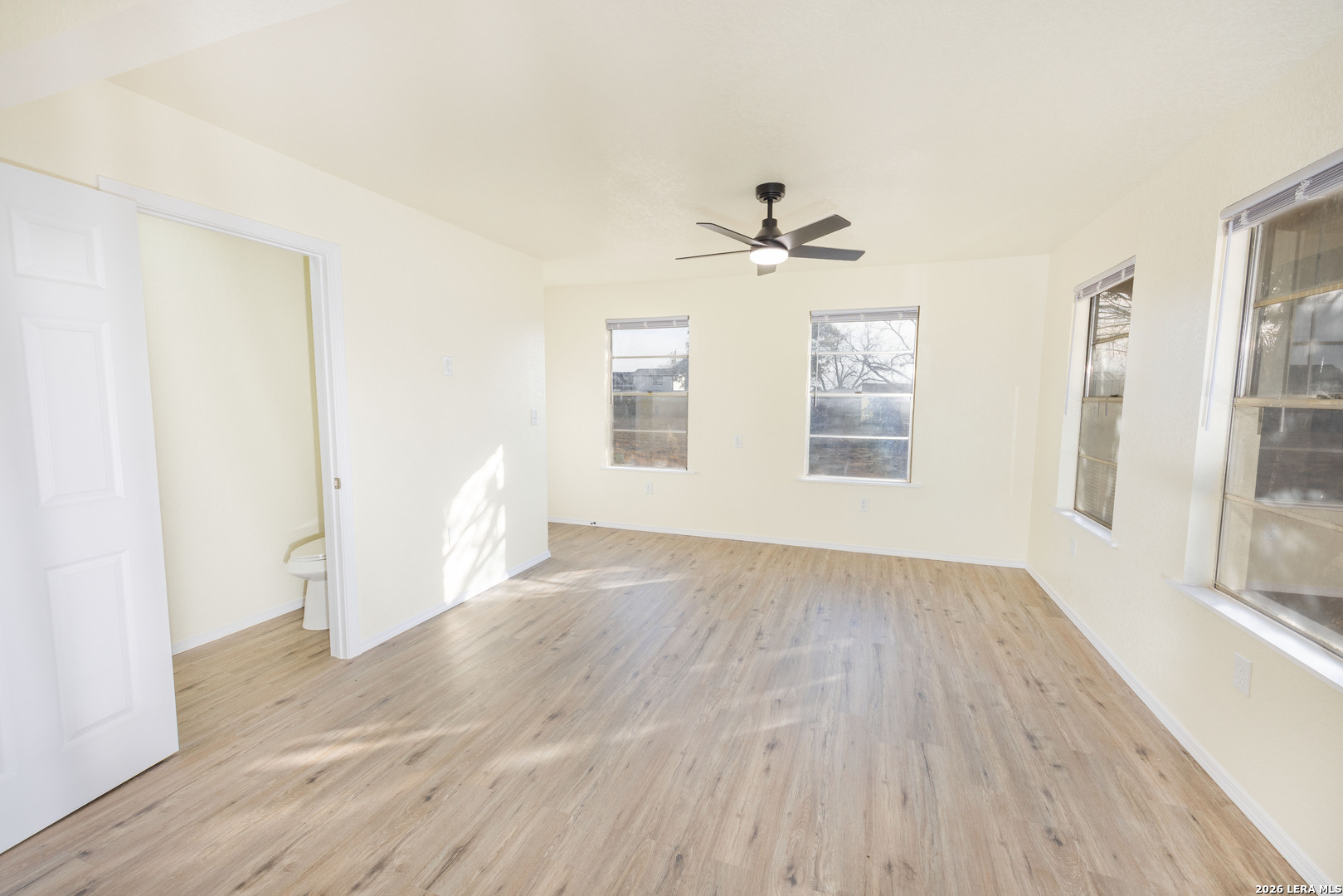 523 A Rossville Road Devine, TX 78016 - Photo 7 of 31 a view of empty room with wooden floor and fan