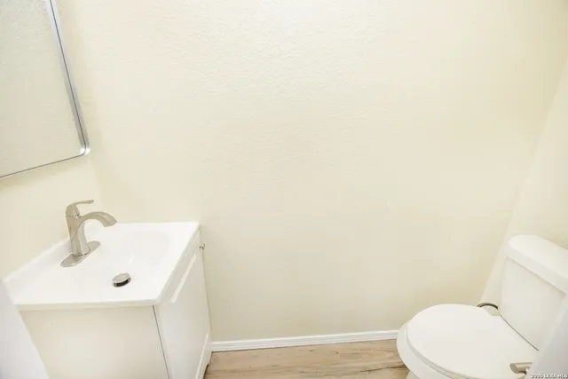 a white toilet sitting next to a white sink