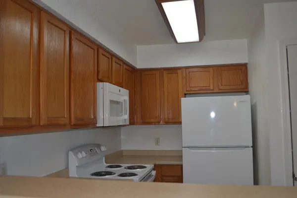 a kitchen with a refrigerator and cabinets