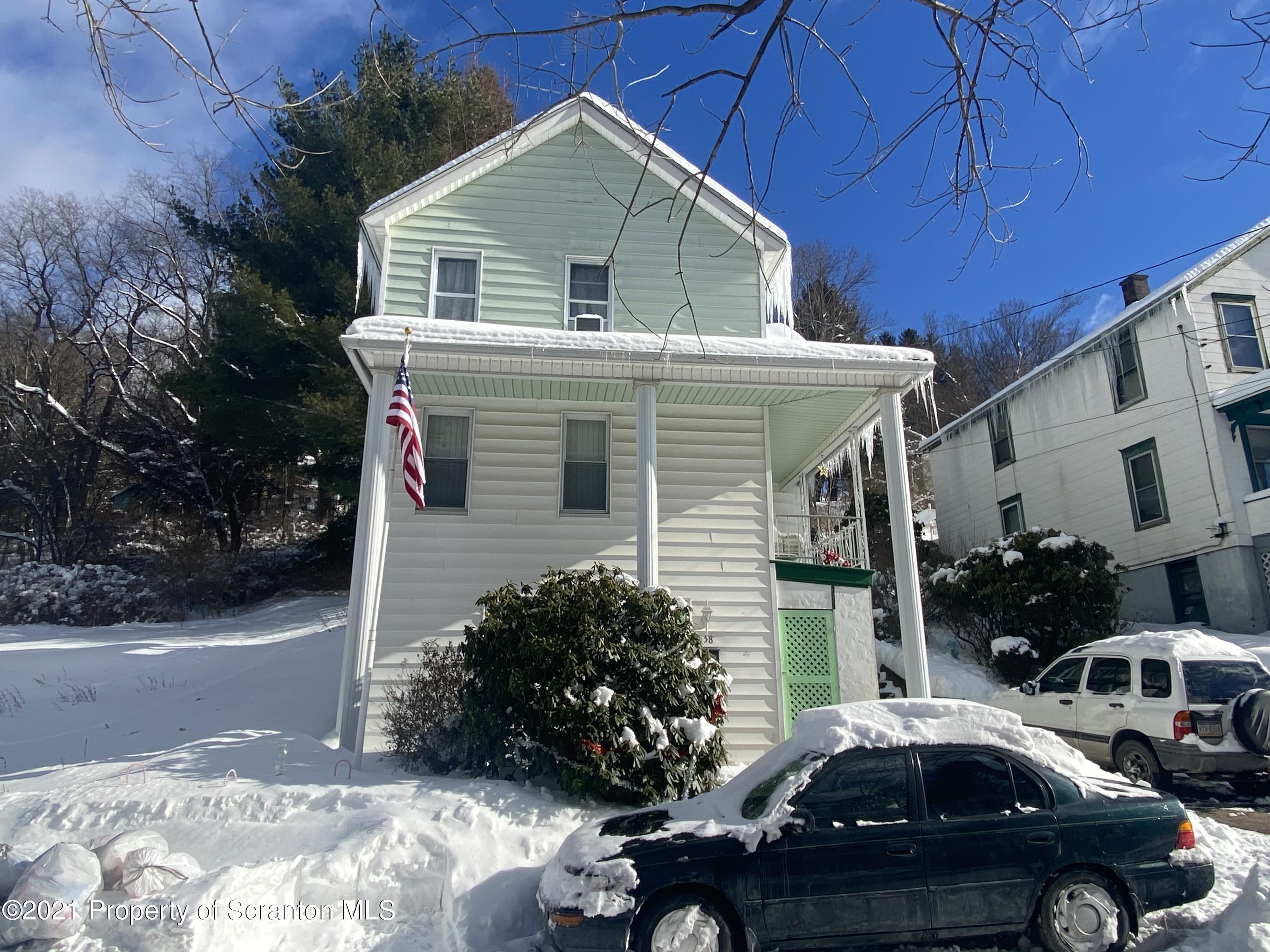 58 Owego Street Simpson, PA 18407 - Photo 2 of 9 a front view of a house with a garden