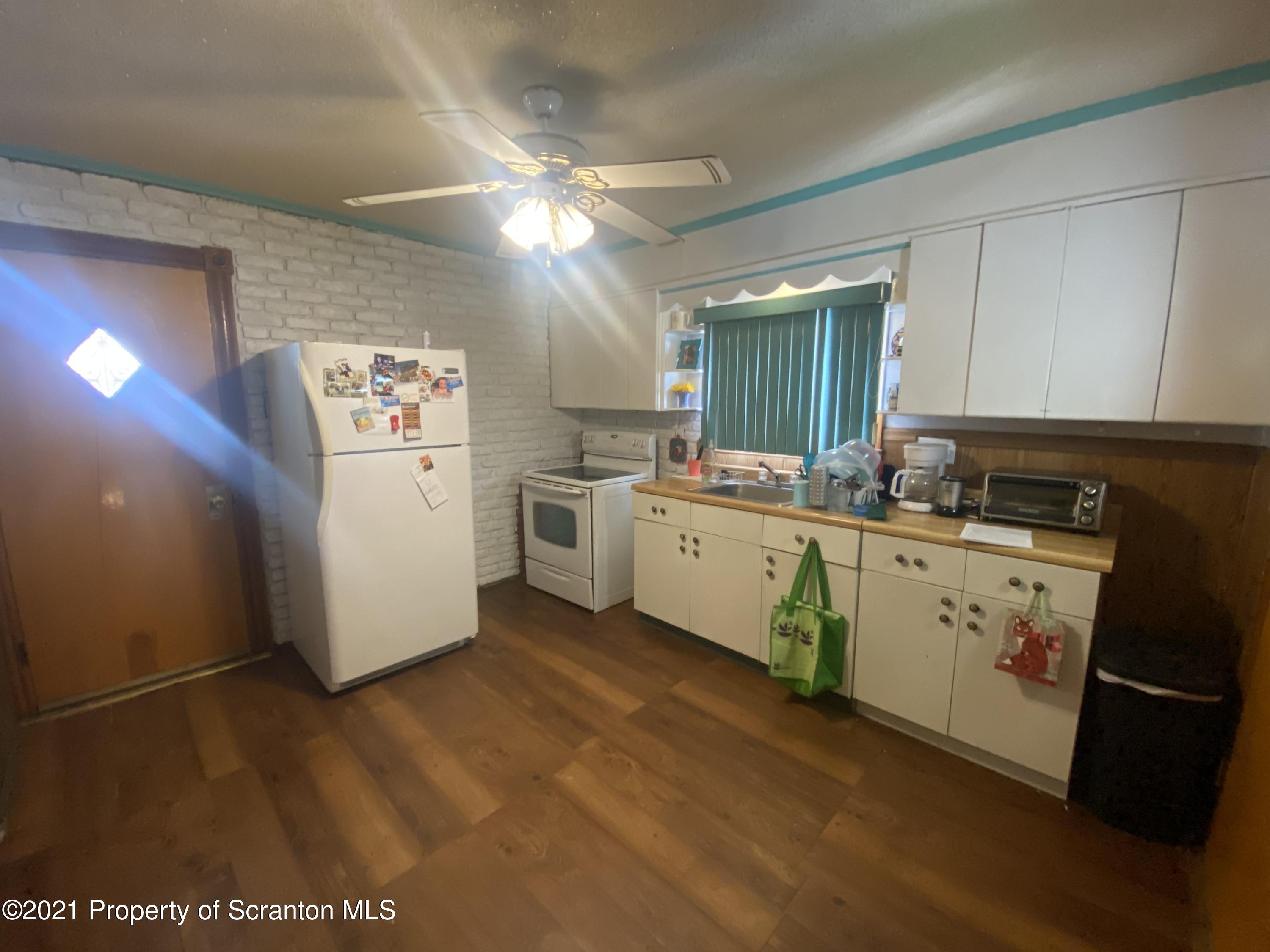 58 Owego Street Simpson, PA 18407 - Photo 4 of 9 a kitchen with cabinets a sink and appliances