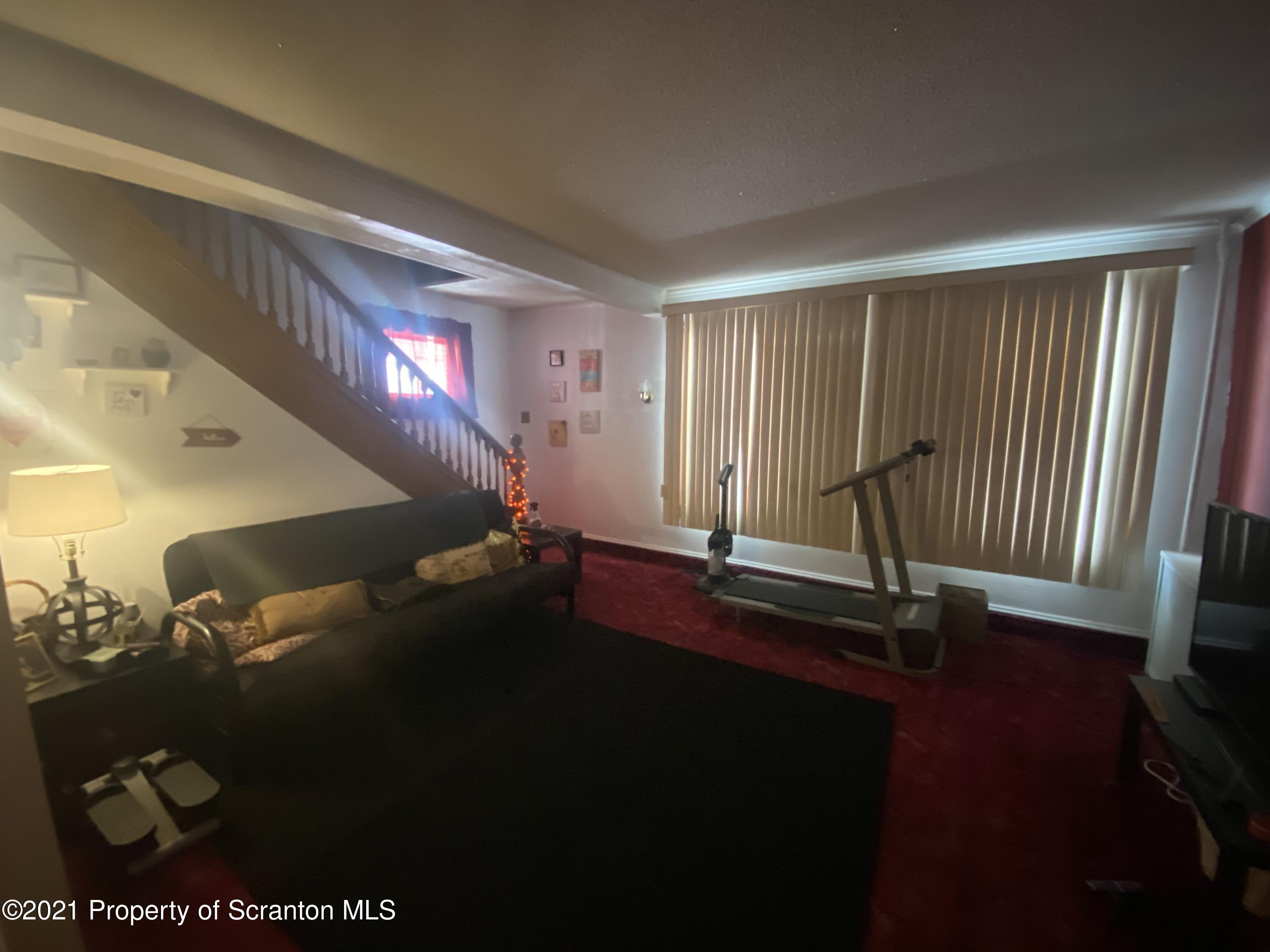 58 Owego Street Simpson, PA 18407 - Photo 6 of 9 a room with lots of trees