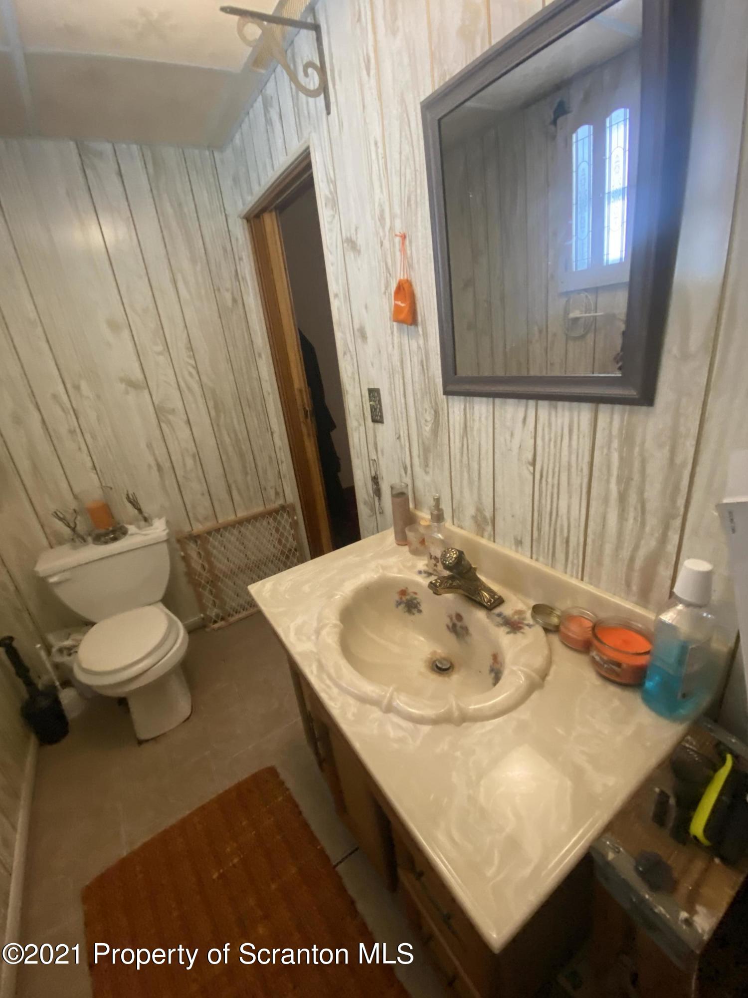 58 Owego Street Simpson, PA 18407 - Photo 8 of 9 a bathroom with a sink and a mirror