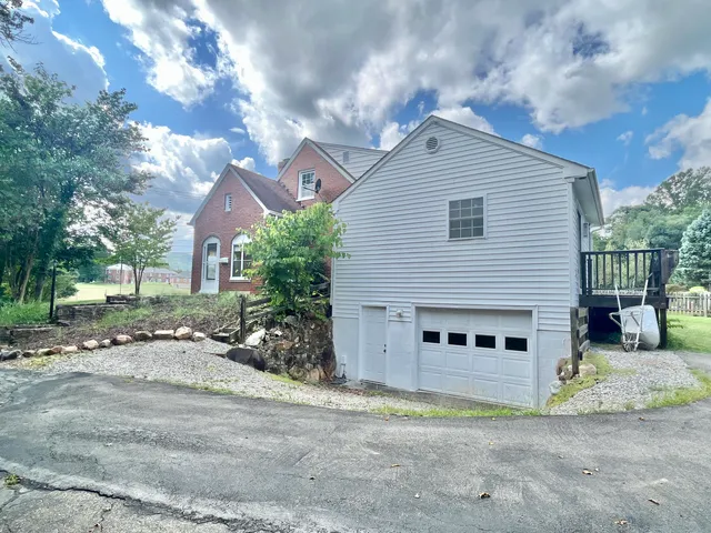 a view of a house with a yard and garage