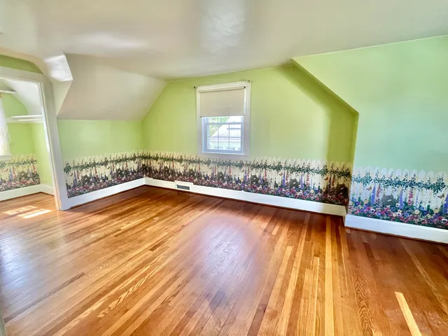 a view of a room with wooden floor