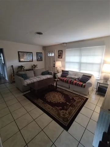 a living room with hard wood floor and furniture