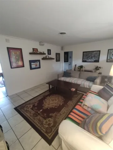 a living room with furniture and a rug