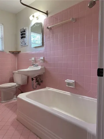 a bathroom with a sink a toilet and bathtub