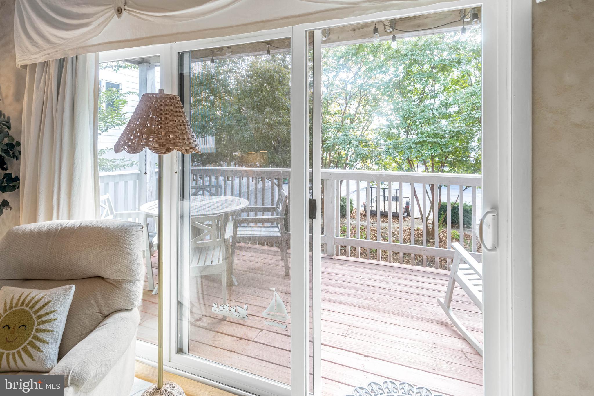11 144th Street, Unit 102 Ocean City, MD 21842 - Photo 14 of 27 a view of a living room and a floor to ceiling window