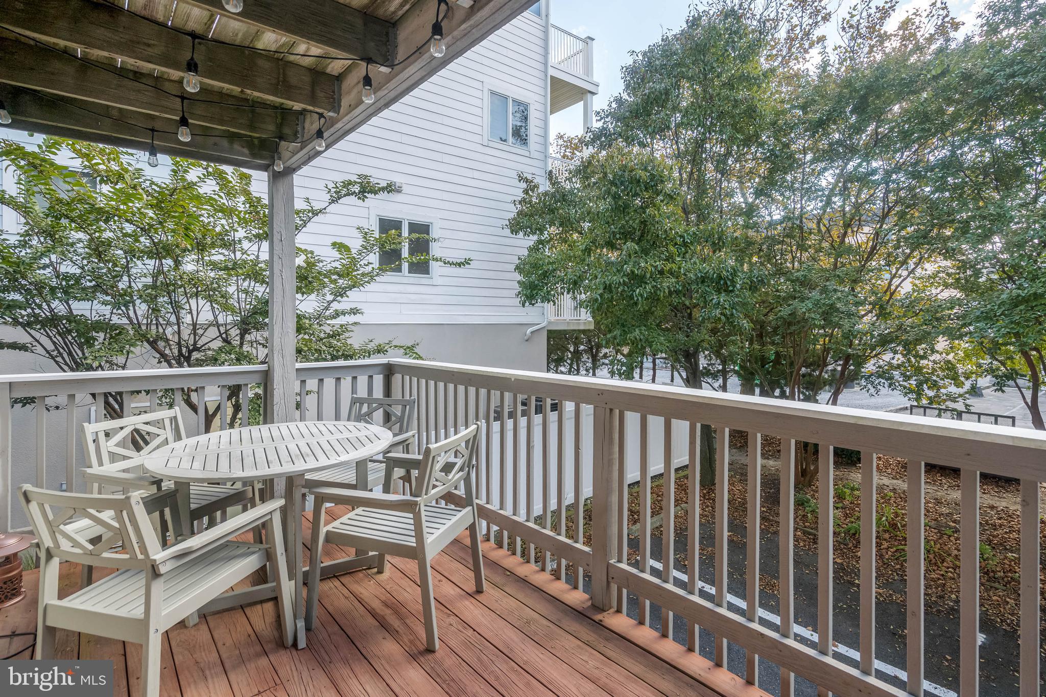 11 144th Street, Unit 102 Ocean City, MD 21842 - Photo 15 of 27 a view of a chairs and table in the balcony
