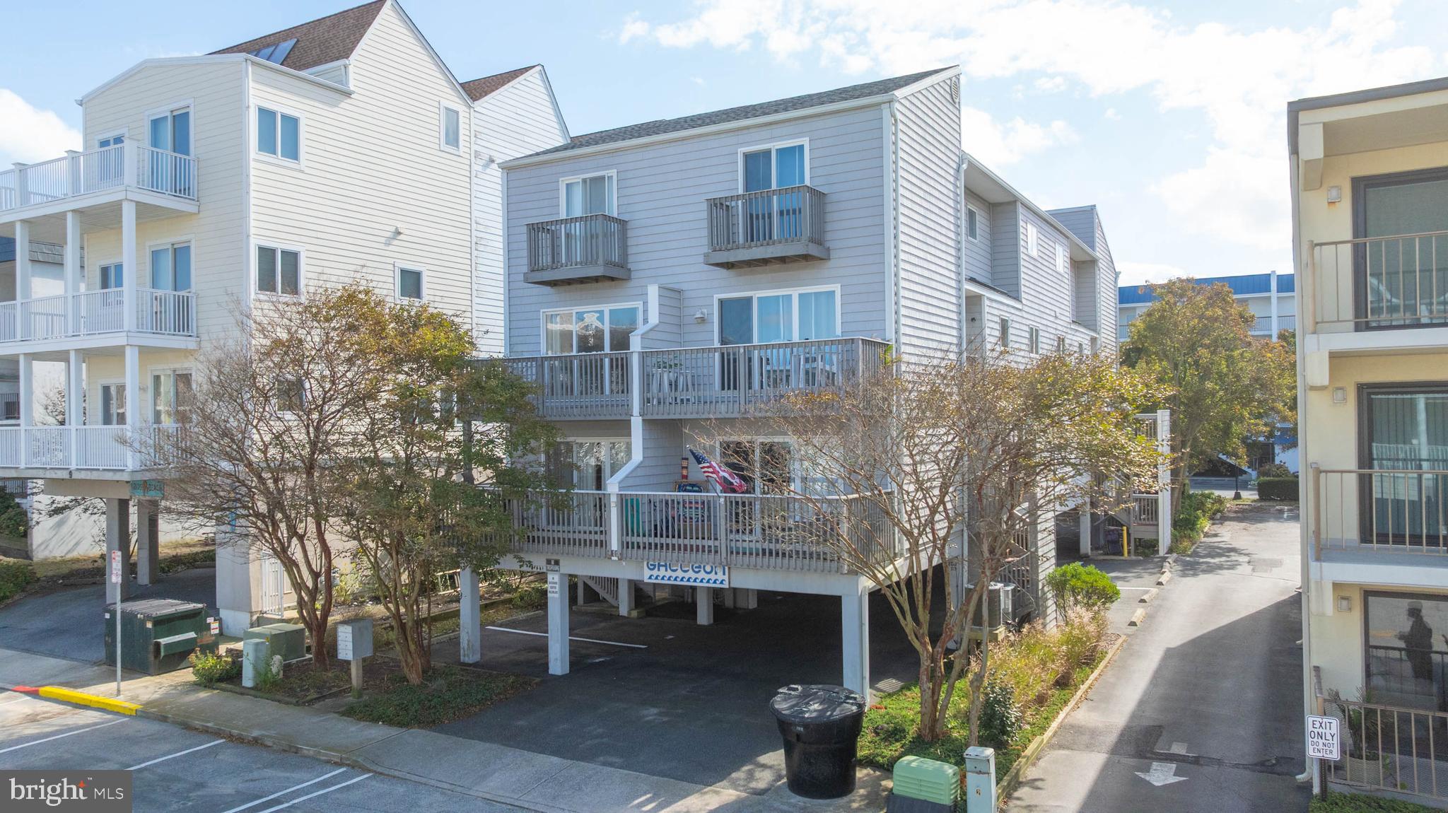 11 144th Street, Unit 102 Ocean City, MD 21842 - Photo 23 of 27 a front view of a building with glass windows and plants