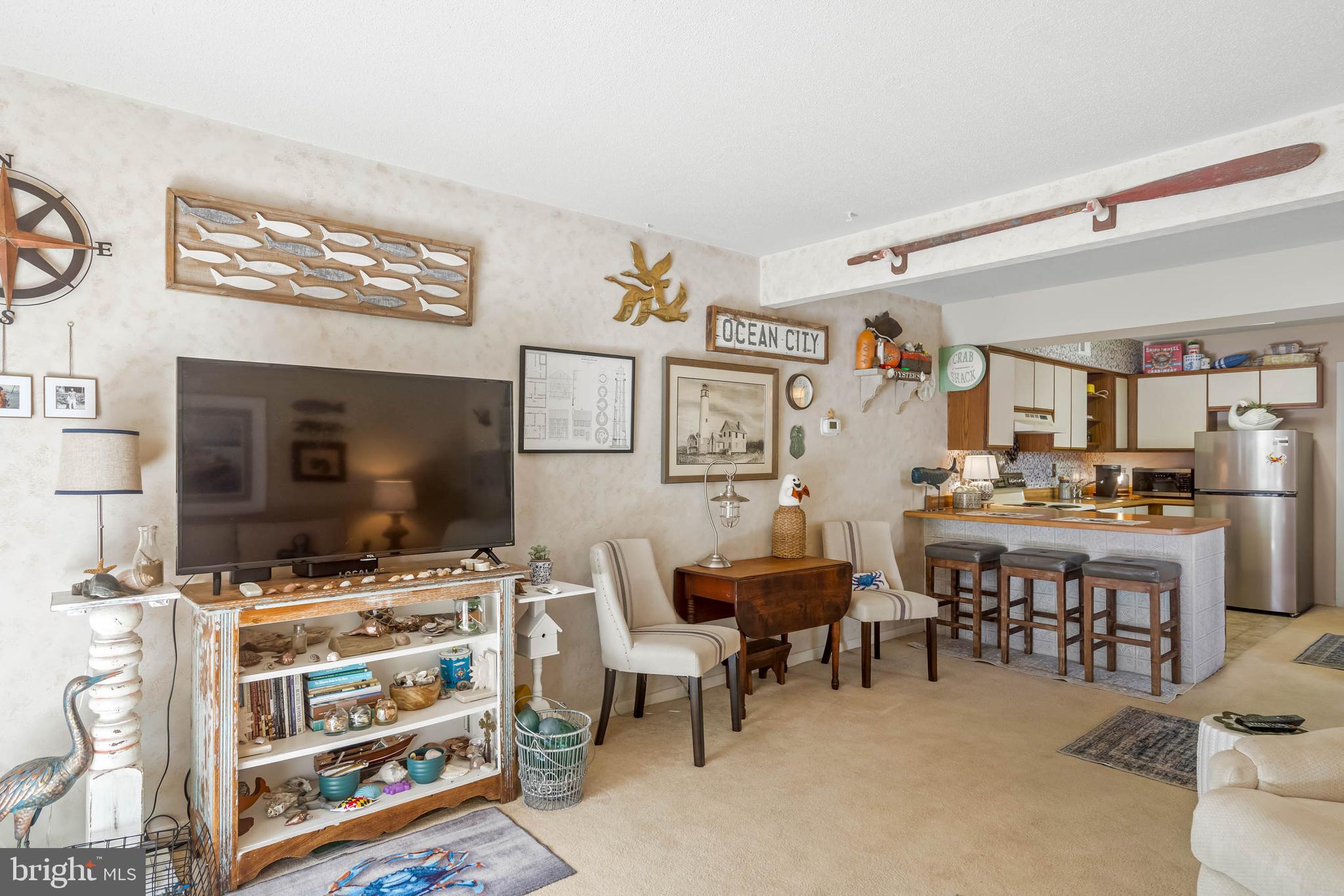 11 144th Street, Unit 102 Ocean City, MD 21842 - Photo 3 of 27 a view of a livingroom with furniture and a flat screen tv
