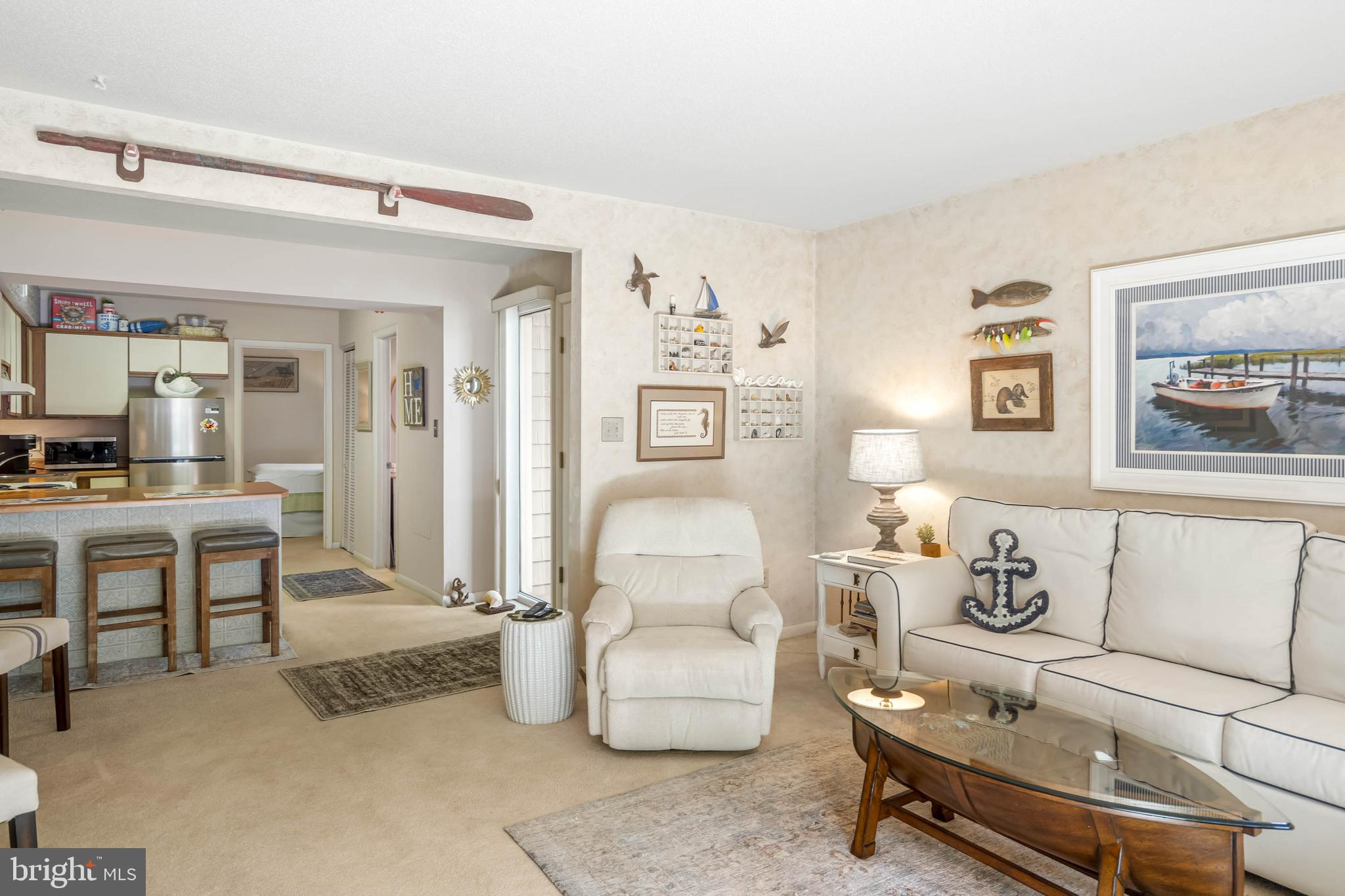 11 144th Street, Unit 102 Ocean City, MD 21842 - Photo 4 of 27 a living room with furniture and a table