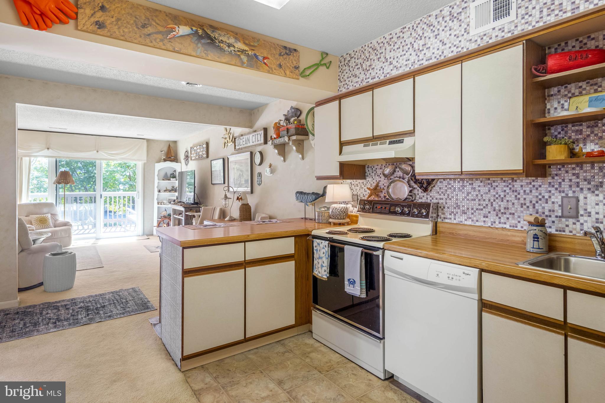 11 144th Street, Unit 102 Ocean City, MD 21842 - Photo 5 of 27 a kitchen with stainless steel appliances granite countertop a sink stove and cabinets