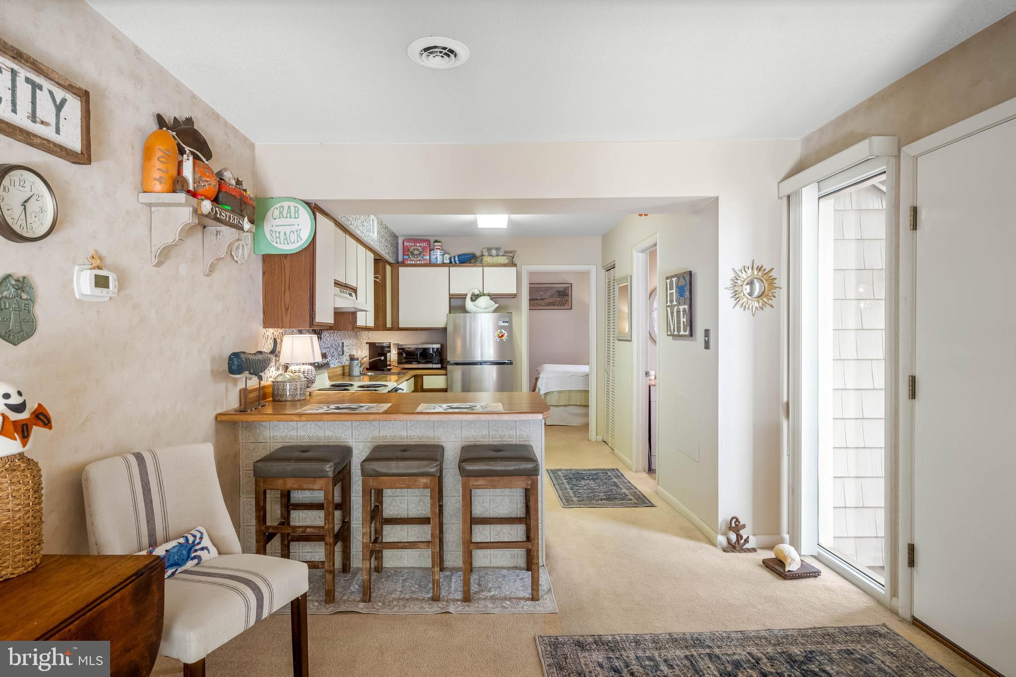 11 144th Street, Unit 102 Ocean City, MD 21842 - Photo 9 of 27 a view of a dining room with furniture