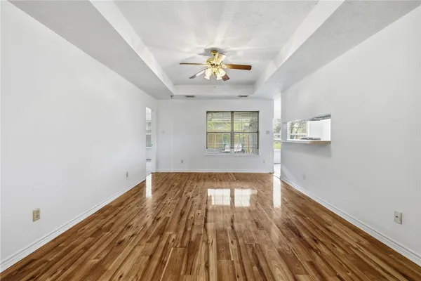wooden floor in an empty room with a window