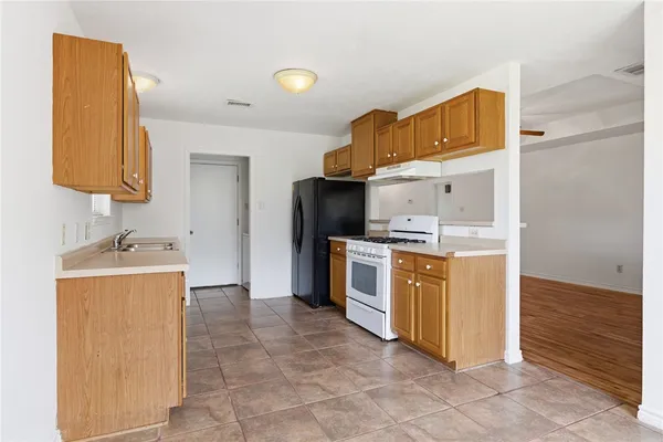a kitchen with granite countertop a sink and cabinets