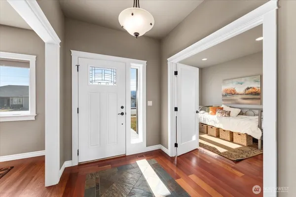 a view of an empty room and wooden floor