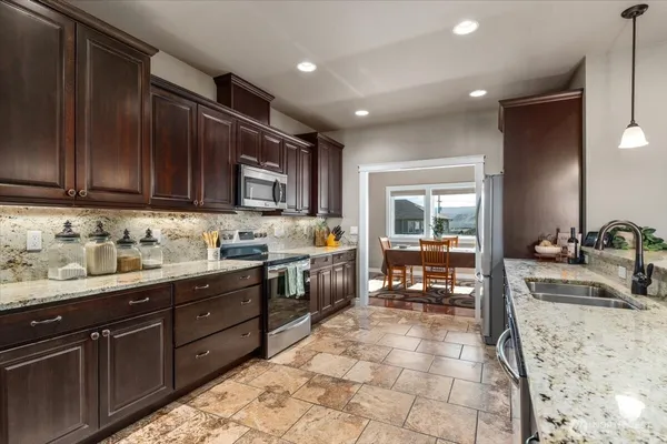 a kitchen with a sink stove and cabinets