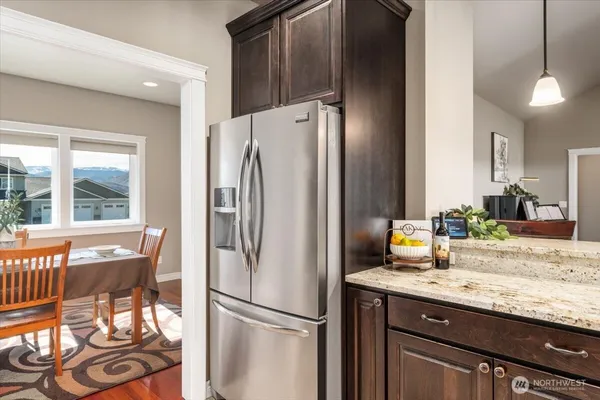 a kitchen with stainless steel appliances granite countertop a refrigerator and a sink