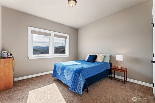 a bedroom with a bed and window