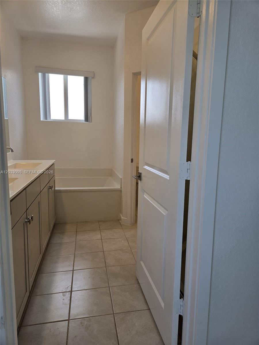862 Southeast 17 Street, Unit 862 Homestead, FL 33034 - Photo 32 of 39 a bathroom with a tub shower and sink