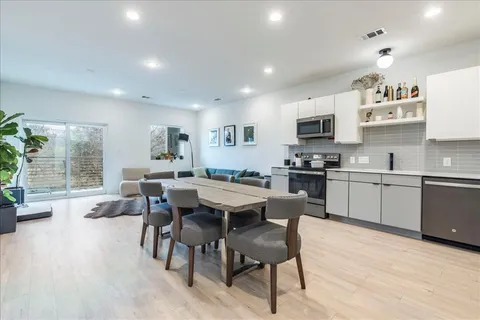 a large kitchen with a table and chairs