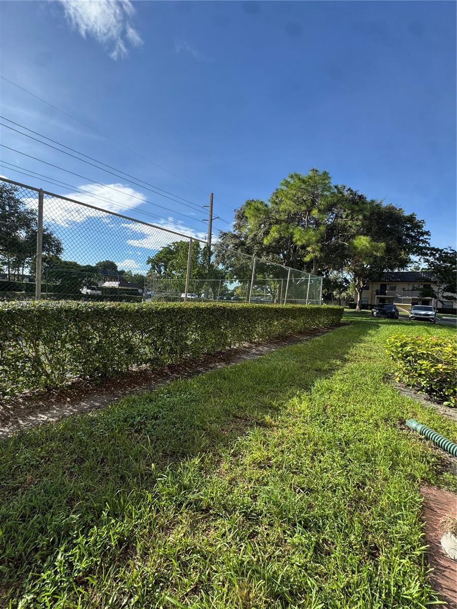 142 Northwest 91st Avenue, Unit 104 Pembroke Pines, FL 33024 - Photo 12 of 15 a view of a park with a big yard