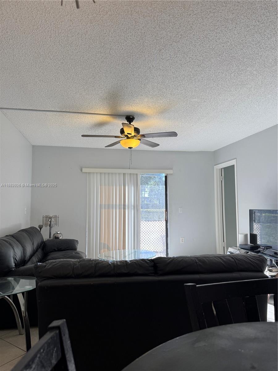 142 Northwest 91st Avenue, Unit 104 Pembroke Pines, FL 33024 - Photo 2 of 15 a living room with furniture