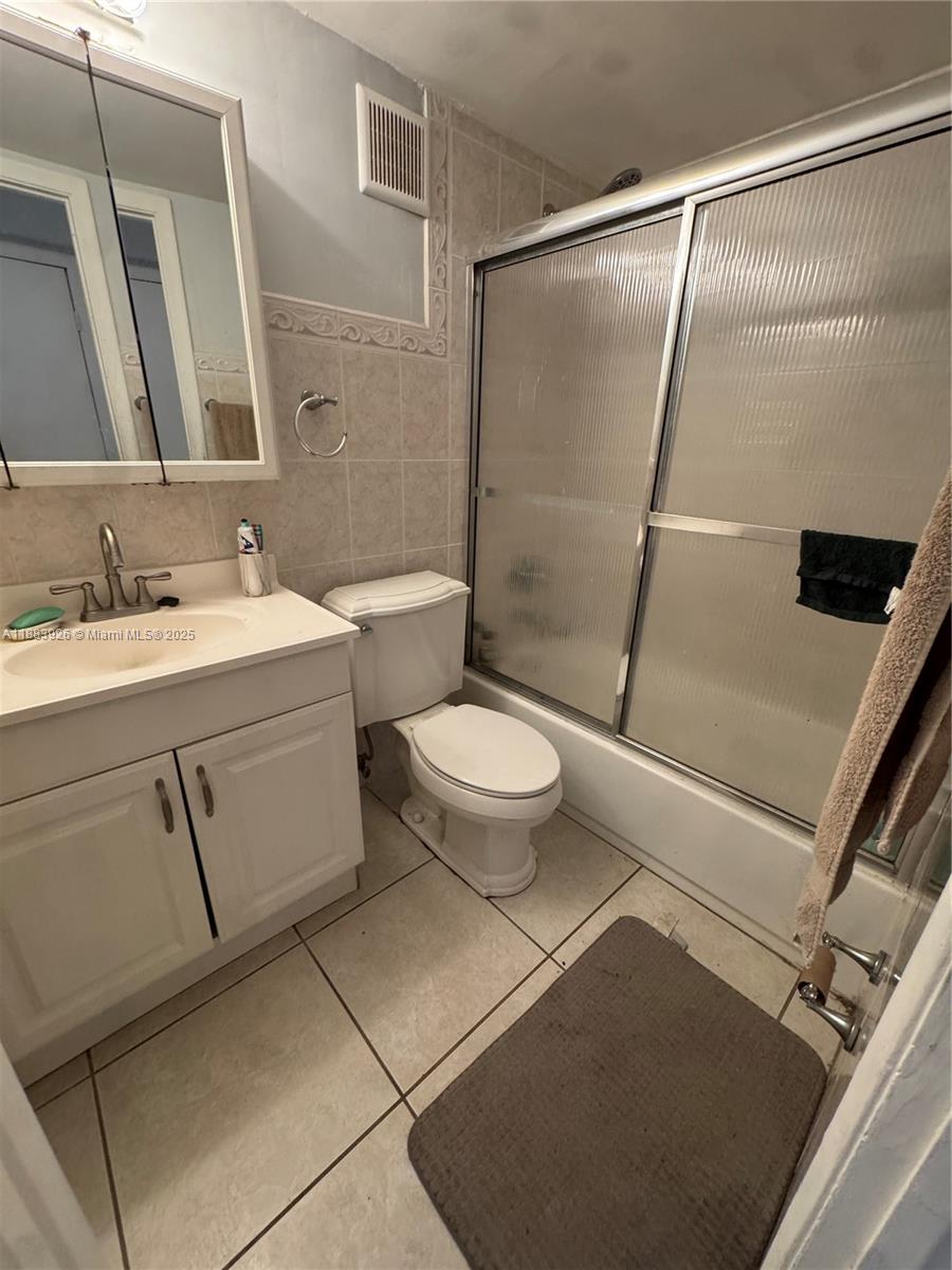 142 Northwest 91st Avenue, Unit 104 Pembroke Pines, FL 33024 - Photo 5 of 15 a bathroom with a sink a toilet a mirror and shower