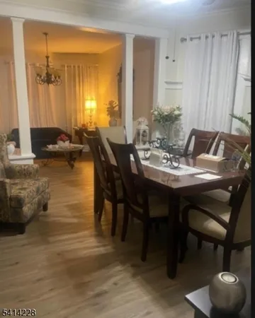 a view of a dining room with furniture and a potted plant