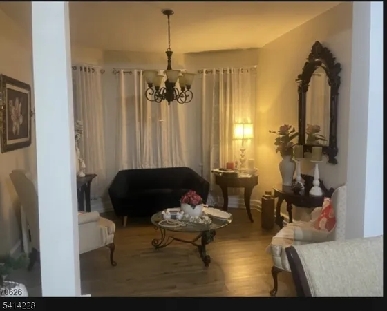 a living room with furniture and a chandelier
