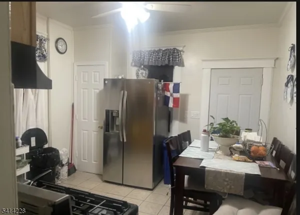 a kitchen with stainless steel appliances granite countertop a refrigerator and a stove