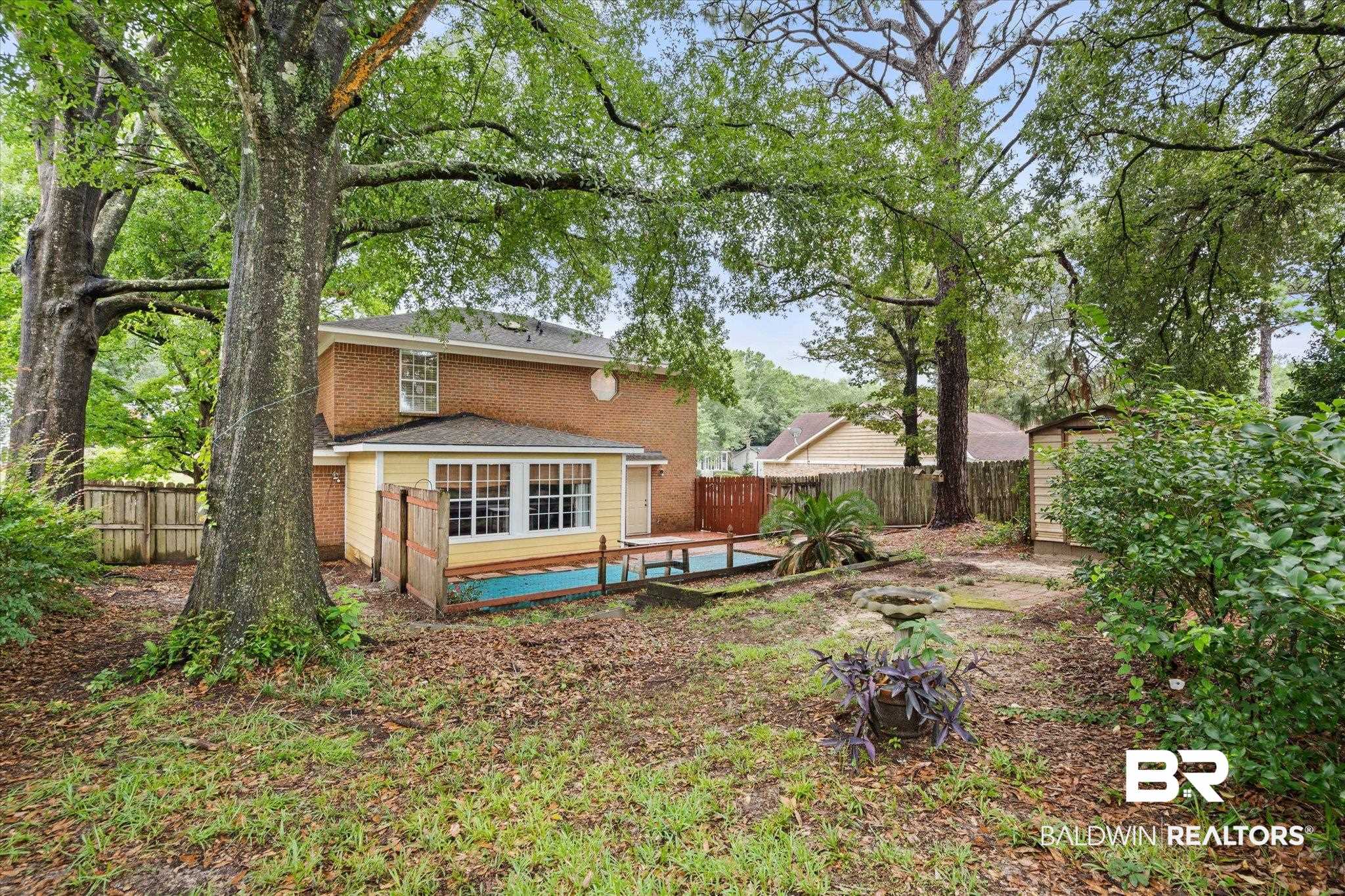 6632 Autumn Ridge Drive Mobile, AL 36695 - Photo 21 of 22 Back of property featuring a fenced backyard, brick siding, and a storage shed
