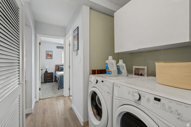 730 Geranium Street Sandy, UT 84094 - Photo 21 of 35 In-unit laundry appliances with overhead cabinetry, wood-finish flooring, and light-toned walls