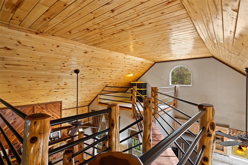 5066 Bob O Link Road Gilmer, TX 75645 - Photo 13 of 30 a roof deck with table and chairs and wooden floor