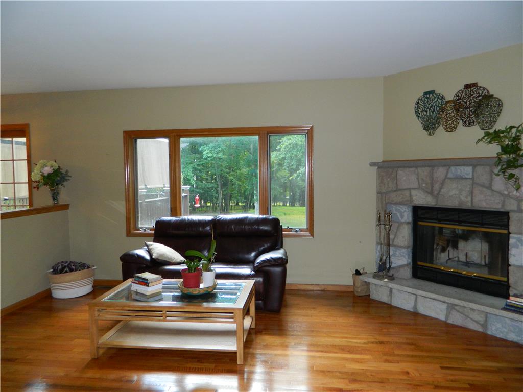 328 Pin Oak Road Stroudsburg, PA 18360 - Photo 17 of 42 Sun-filled living space offers gleaming hardwood floors and a cozy stone fireplace.