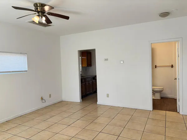 a view of a room with a walk in closet and wooden cabinet