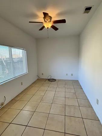 a view of a room with a sink and cabinets