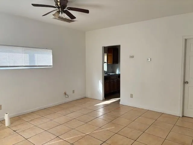a view of a room with window and ceiling fan