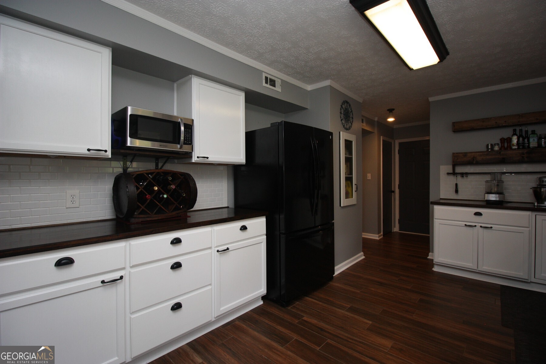 231 Murphy Road LaGrange, GA 30240 - Photo 4 of 24 a kitchen with granite countertop white cabinets and refrigerator