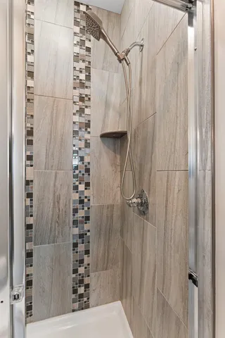 a bathroom with a shower and a sink