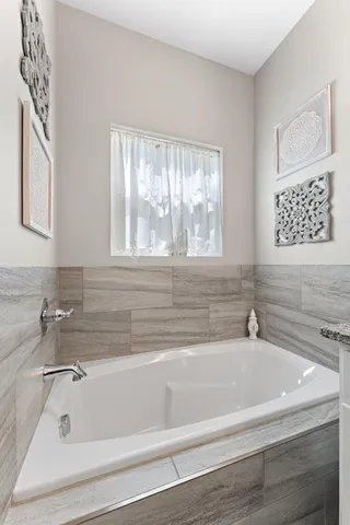 a white bath tub sitting next to a window