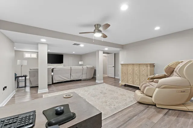 a living room with furniture and kitchen view