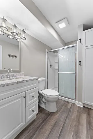 a bathroom with a toilet a sink and a mirror